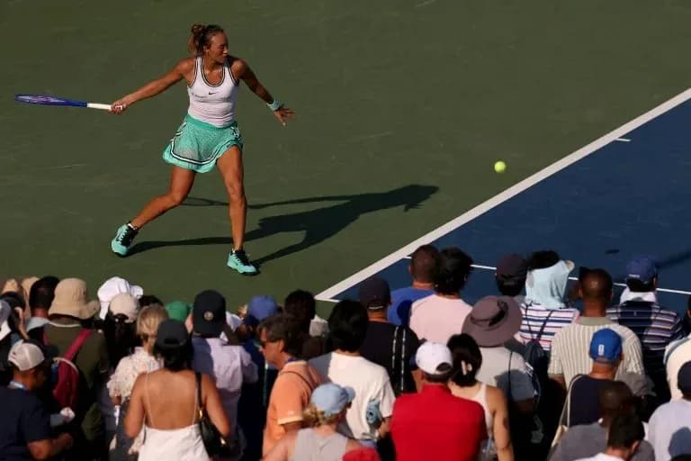 Female tennis player hitting a forehand shot Female tennis player hitting a forehand shot