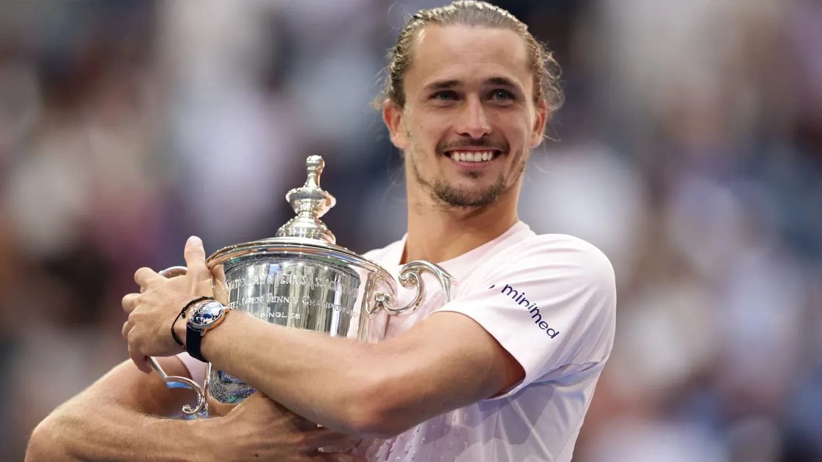Player holding trophy after winning tennis championship Player holding trophy after winning tennis championship