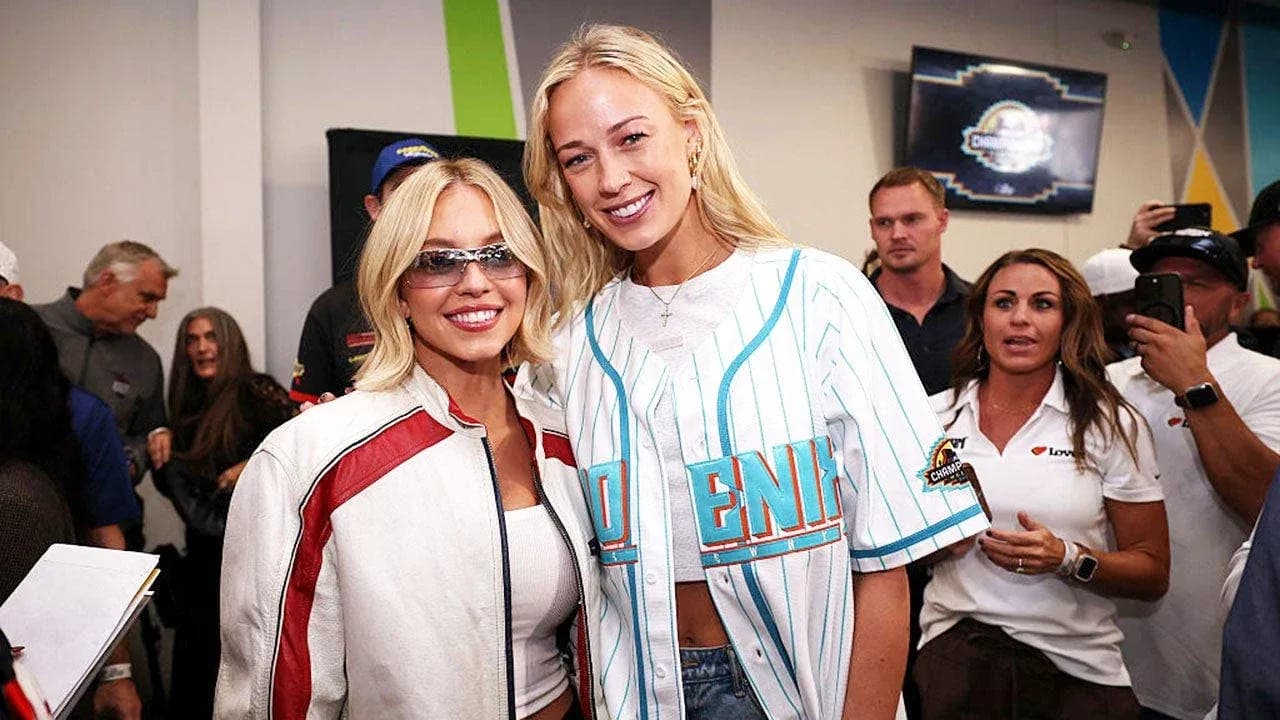 Two women posing together at an event Two women posing together at an event