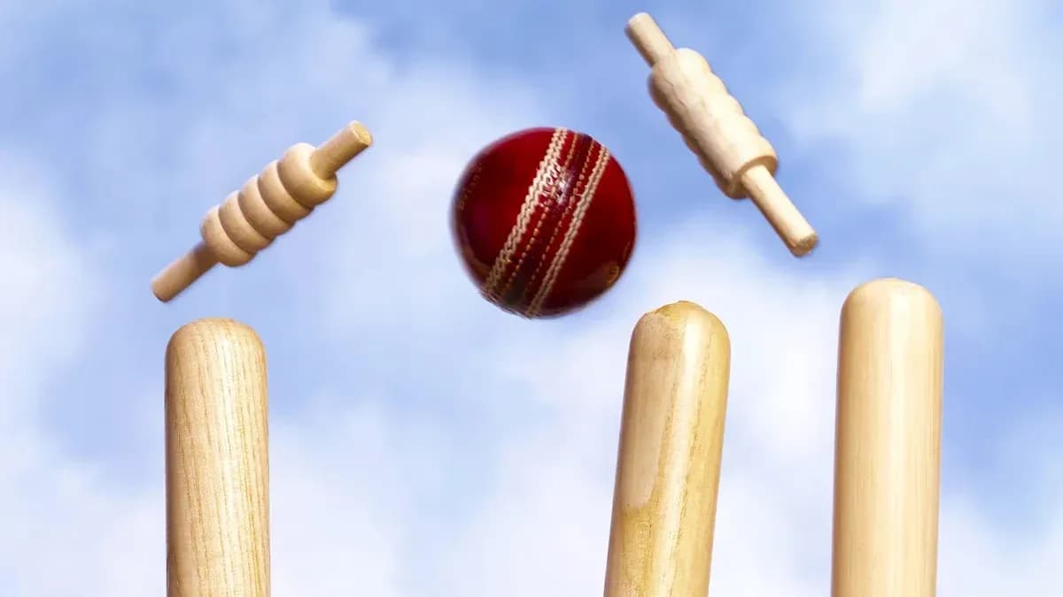 Cricket ball hitting stumps with bails above Cricket ball hitting stumps with bails above