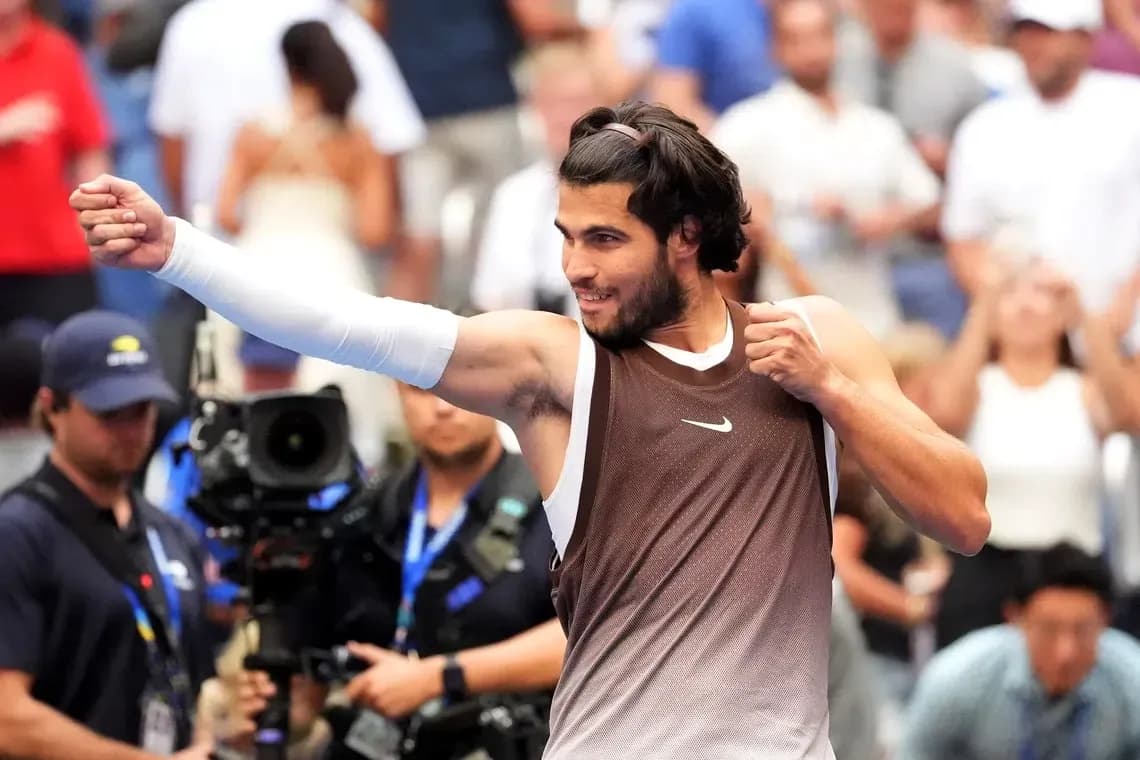 Tennis player celebrating after a match victory Tennis player celebrating after a match victory