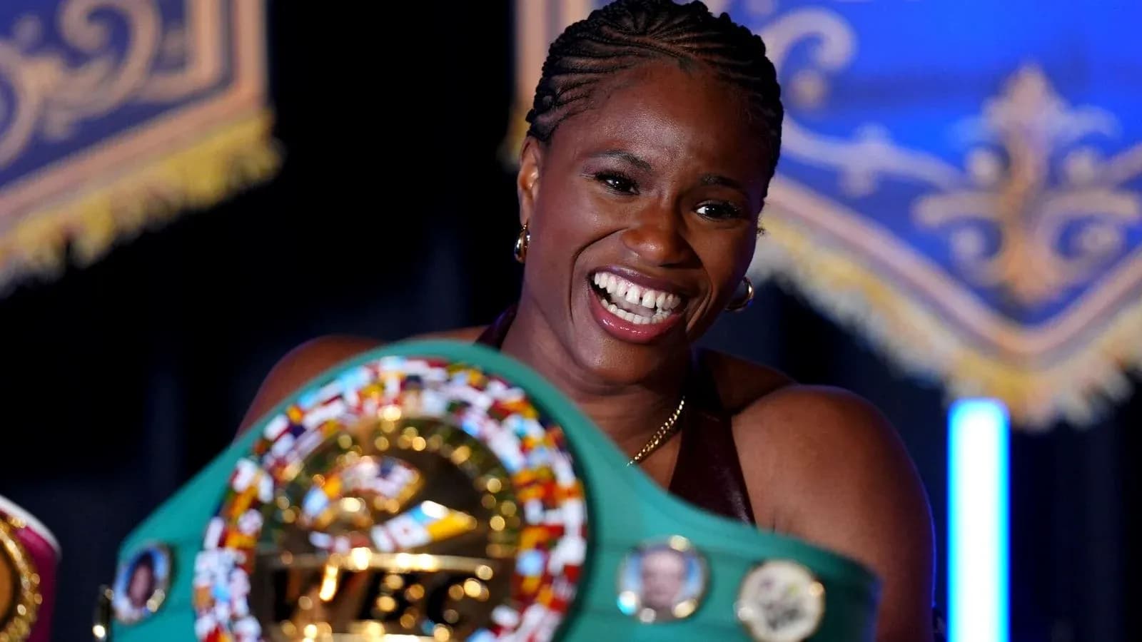 Boxer smiling while holding championship belt Boxer smiling while holding championship belt