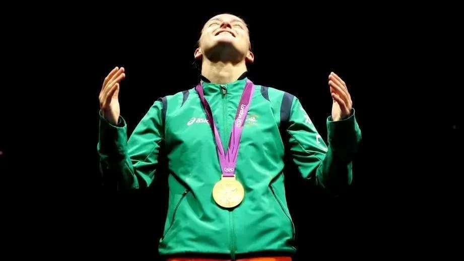 Athlete celebrating with gold medal in dark setting Athlete celebrating with gold medal in dark setting
