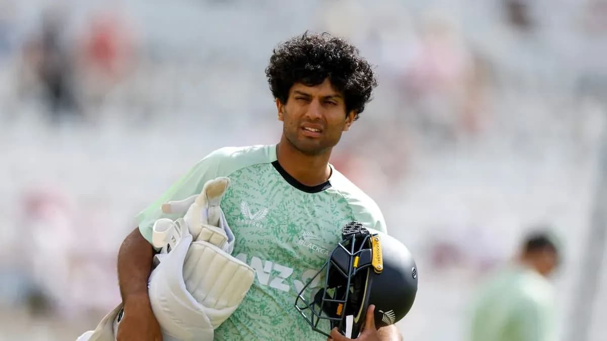 Cricketer walking off field with gear in hand Cricketer walking off field with gear in hand