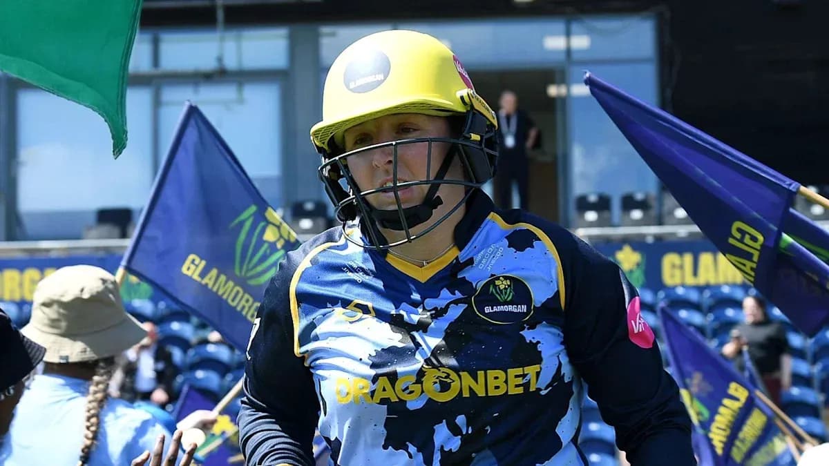 Cricketer from Glamorgan entering the field with flags Cricketer from Glamorgan entering the field with flags