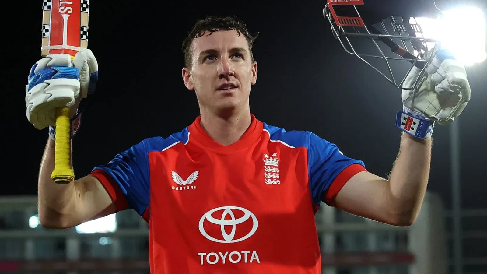 Batsman celebrating with bat raised after scoring Batsman celebrating with bat raised after scoring