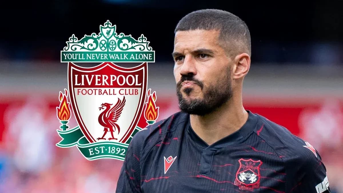 Player in Liverpool FC jersey near club logo Player in Liverpool FC jersey near club logo