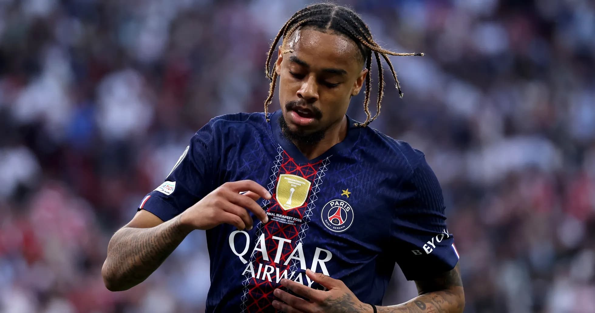 Player inspecting badge on Paris Saint-Germain jersey Player inspecting badge on Paris Saint-Germain jersey