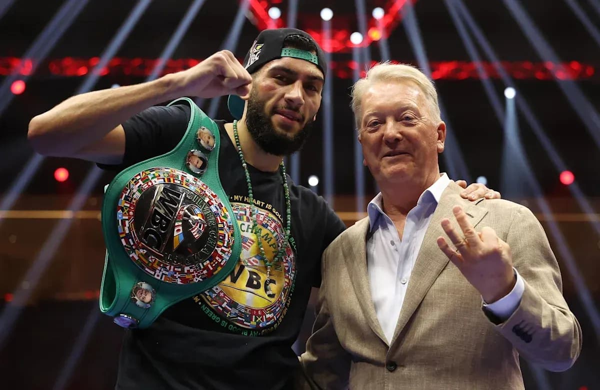 Boxer holding WBC belt with promoter in ring Boxer holding WBC belt with promoter in ring