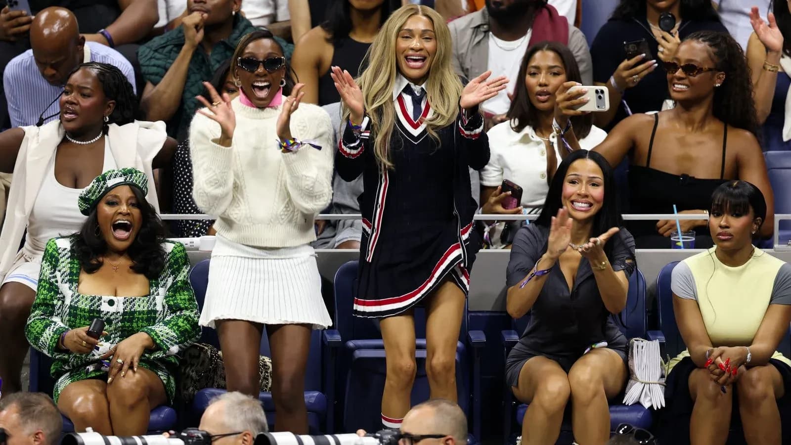 Fans cheering enthusiastically at tennis match Fans cheering enthusiastically at tennis match