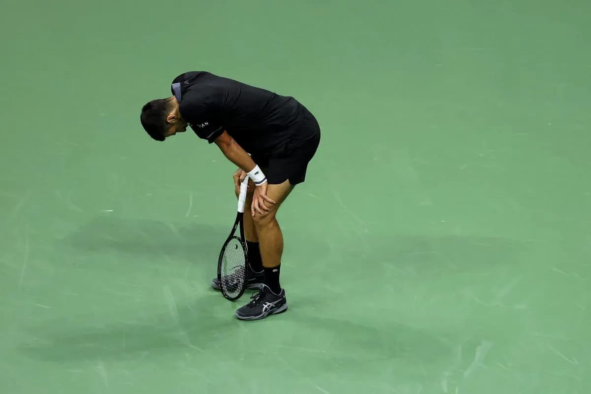Tennis player bending over on court after point Tennis player bending over on court after point