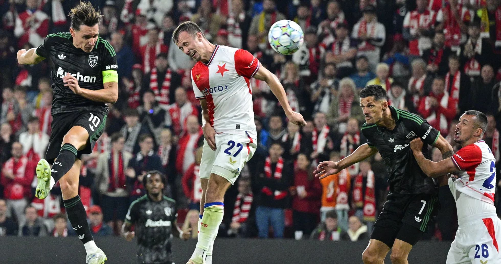 Players contesting a header during a football match Players contesting a header during a football match