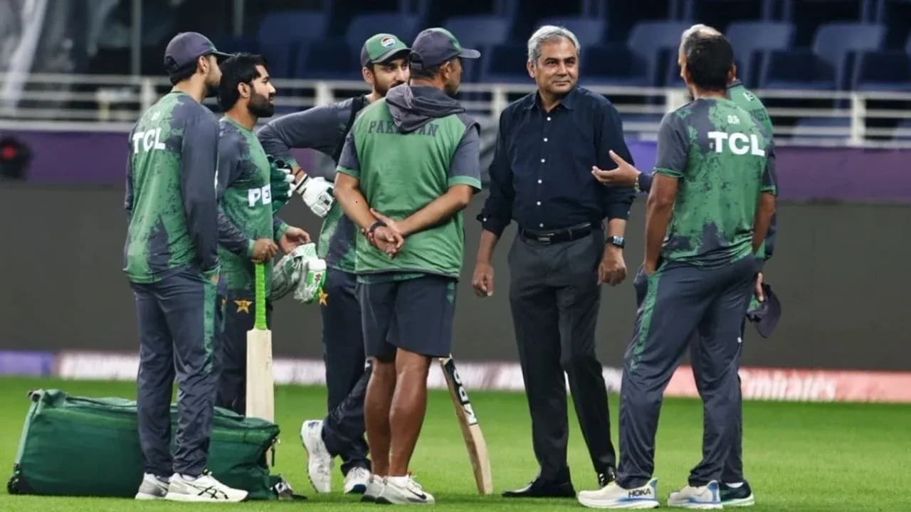 Pakistan cricket team discussing strategy on field Pakistan cricket team discussing strategy on field