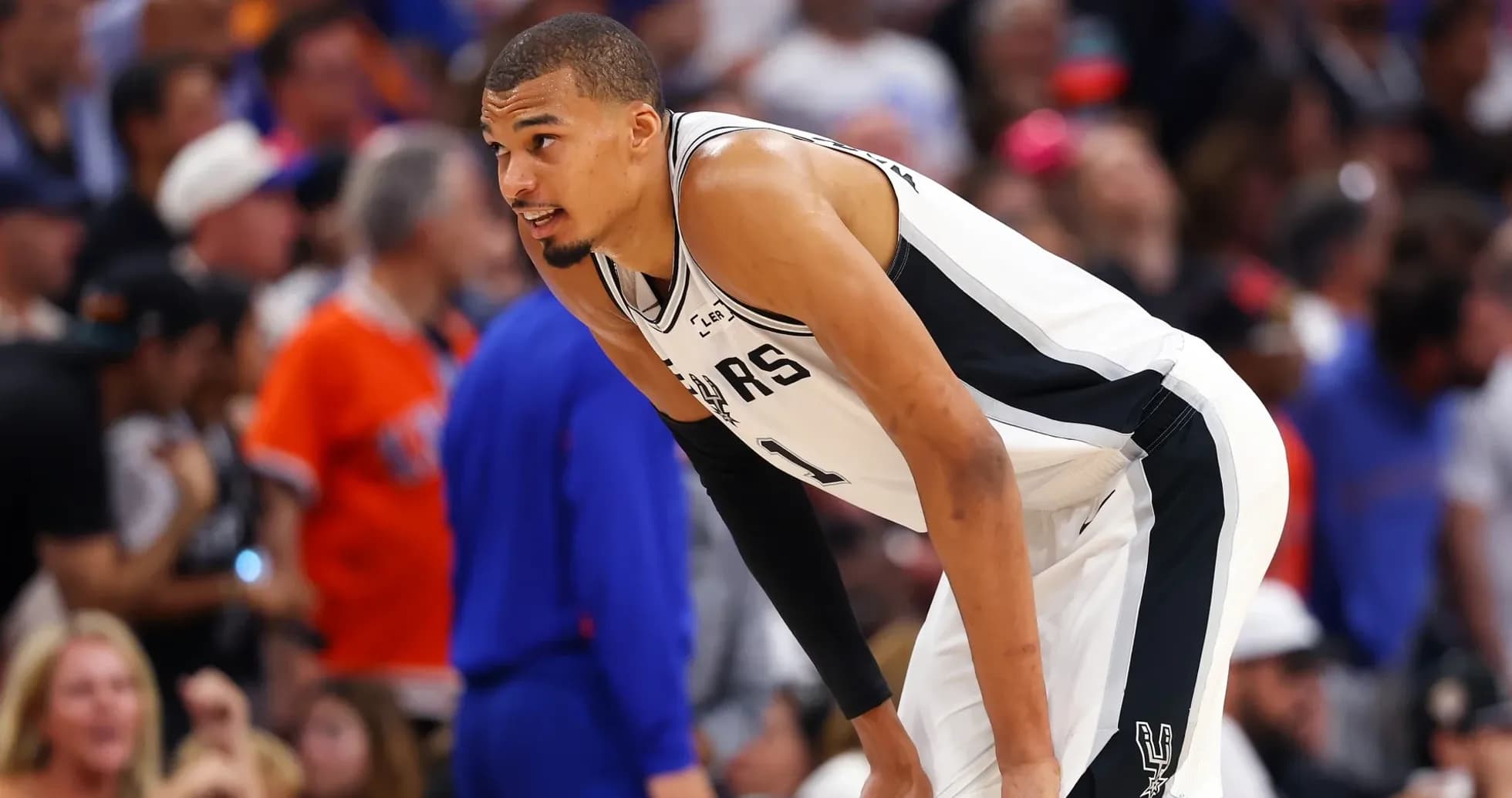 Player in Spurs jersey during game action Player in Spurs jersey during game action