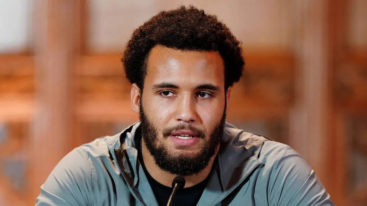 Athlete speaking at a press conference podium Athlete speaking at a press conference podium