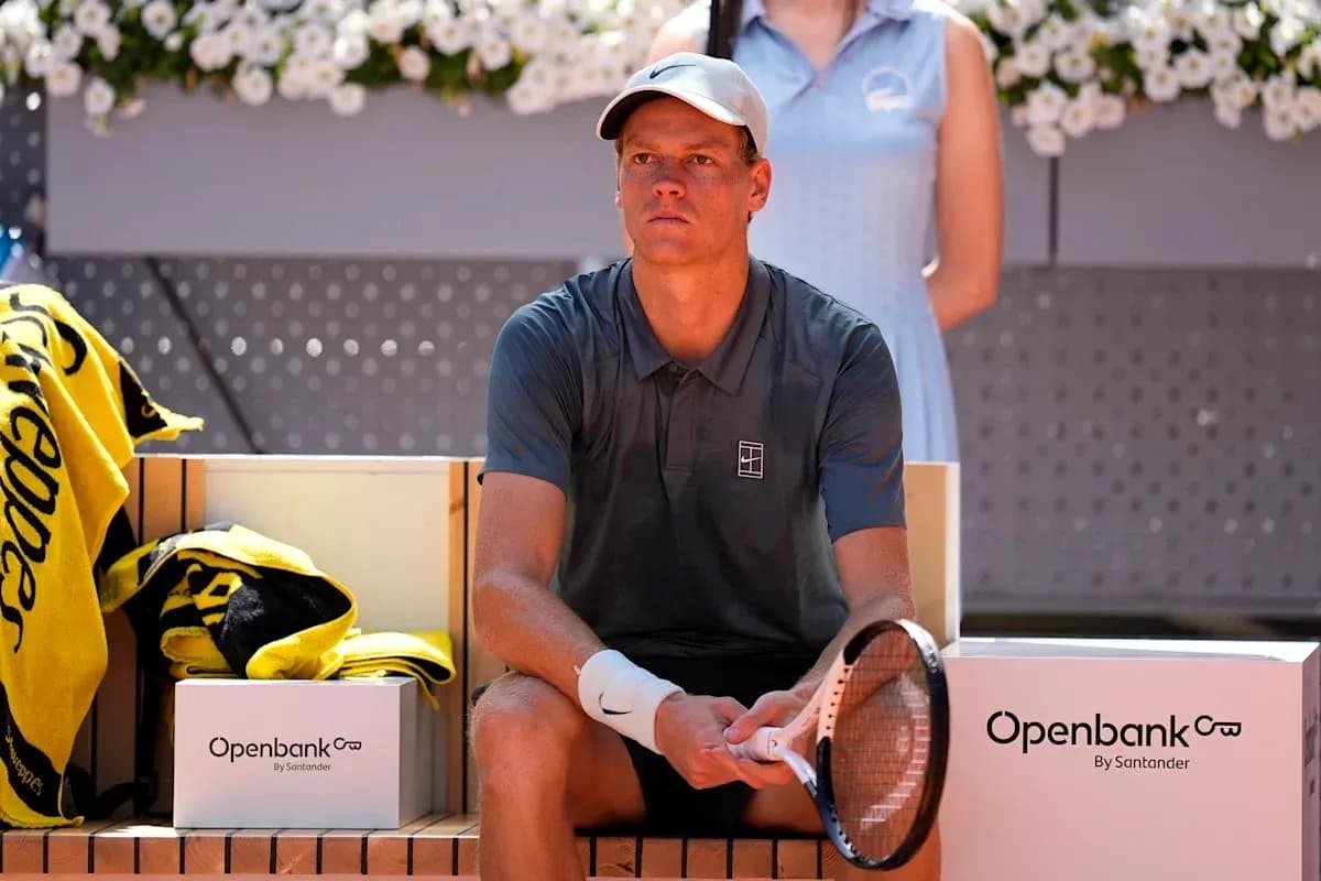 Tennis player sitting on bench during match break Tennis player sitting on bench during match break