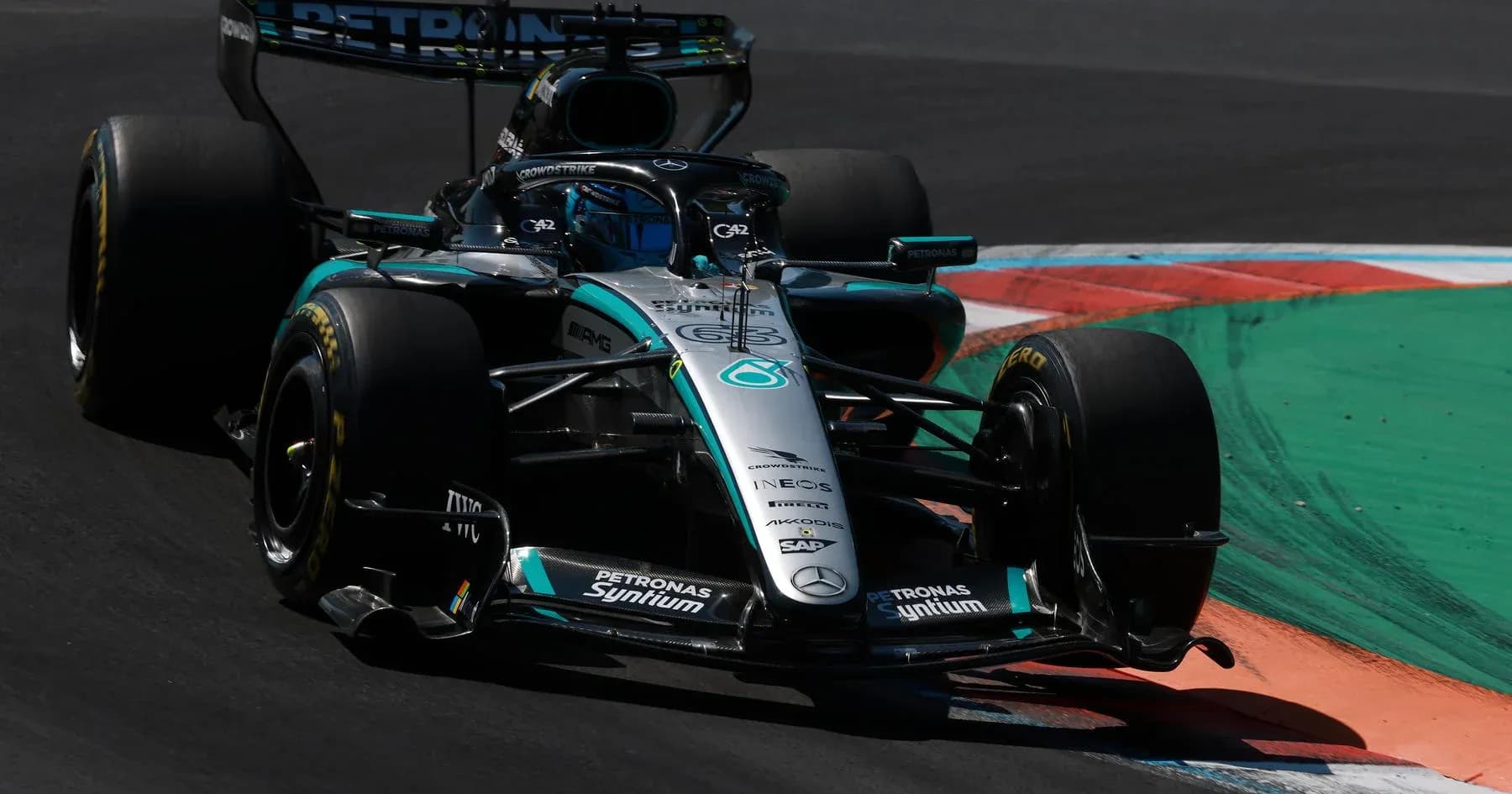 Mercedes Formula 1 car navigating a racing corner Mercedes Formula 1 car navigating a racing corner