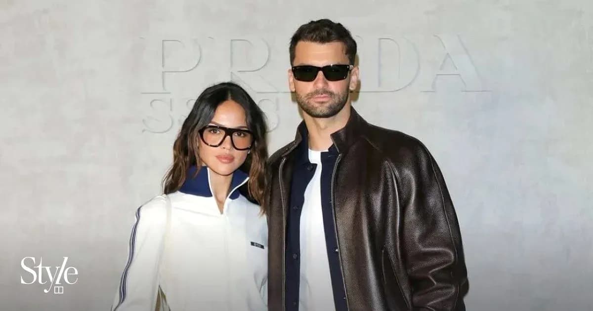 Couple posing in fashionable attire at event Couple posing in fashionable attire at event