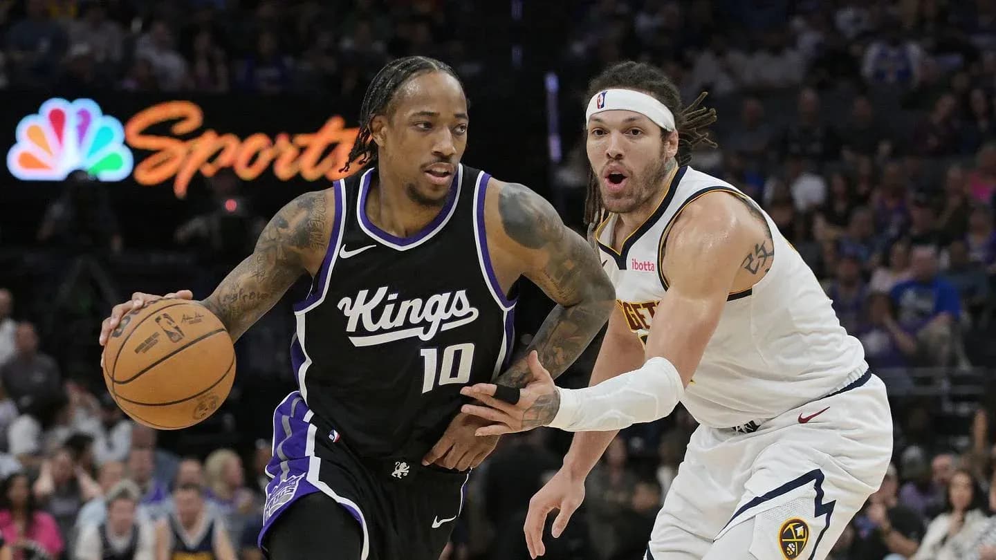 Player dribbling basketball while being defended during game Player dribbling basketball while being defended during game