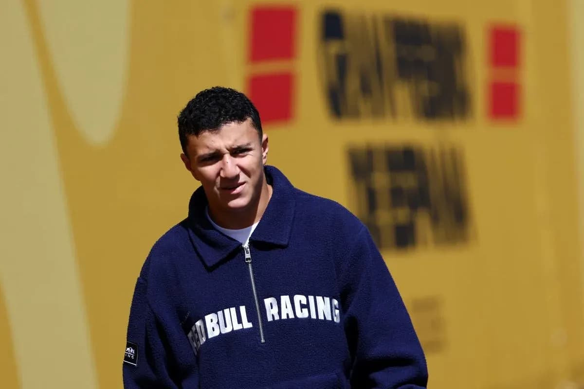 Driver in Red Bull Racing jacket walking outdoors Driver in Red Bull Racing jacket walking outdoors