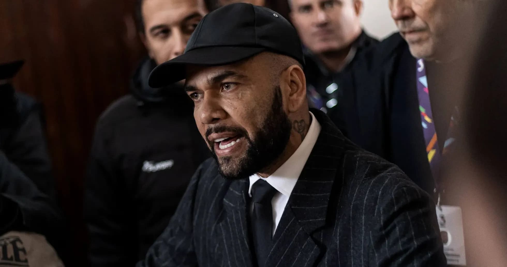 Man in a suit speaking to a crowd Man in a suit speaking to a crowd