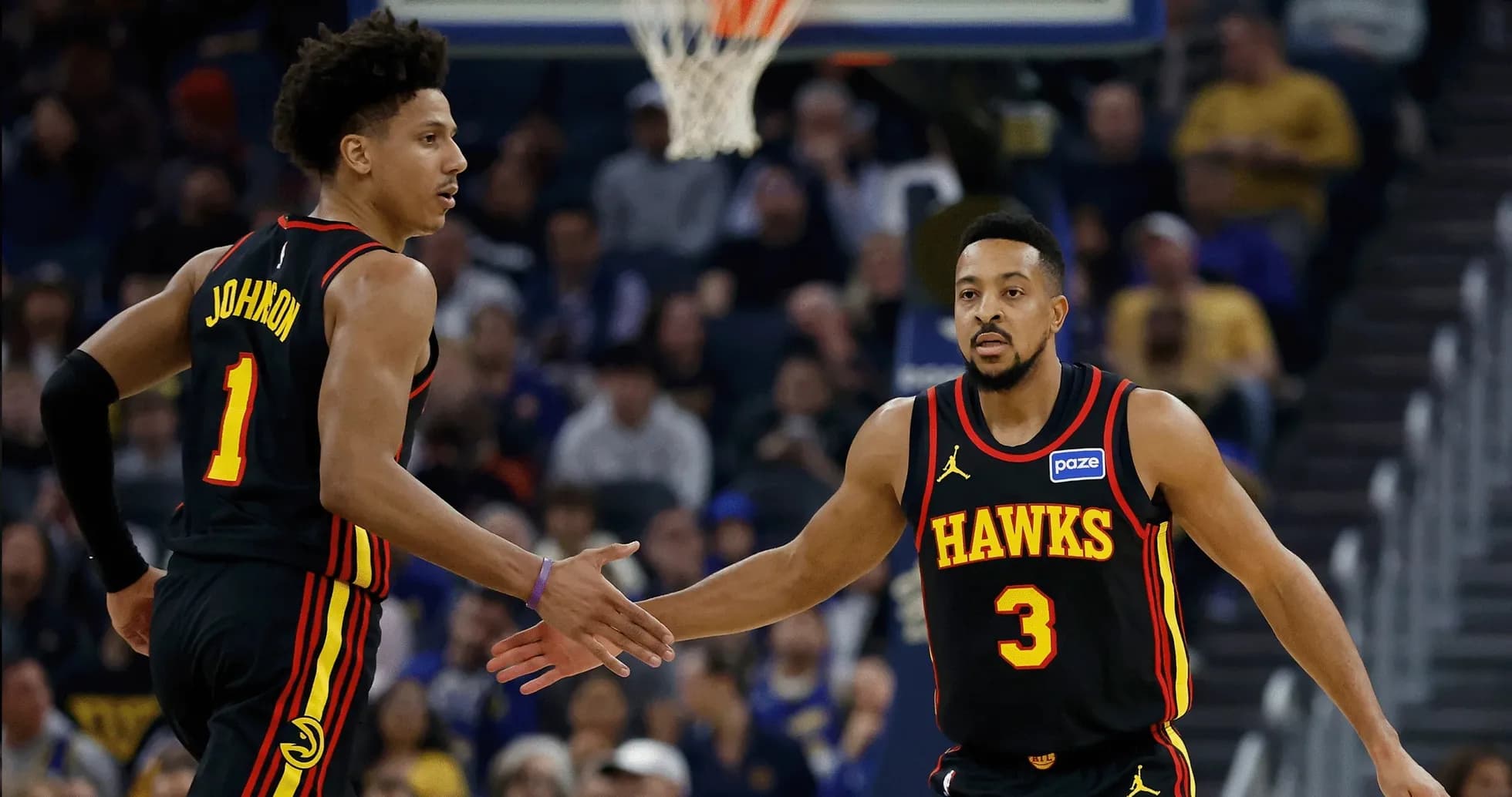 Two Atlanta Hawks players celebrating a play Two Atlanta Hawks players celebrating a play