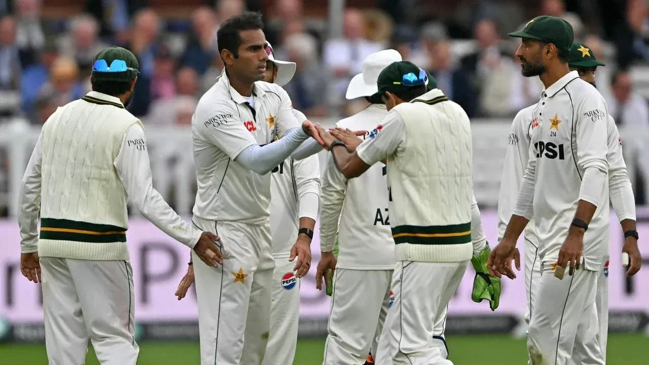 Pakistani cricket players celebrating a wicket on field Pakistani cricket players celebrating a wicket on field