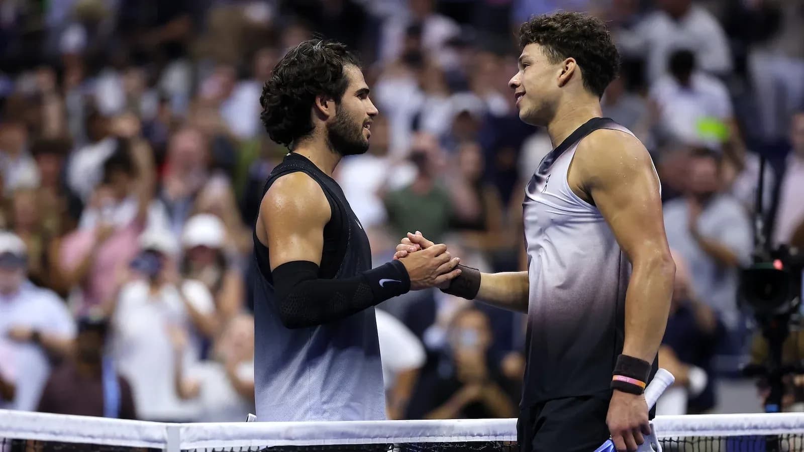 Two tennis players shaking hands at net Two tennis players shaking hands at net