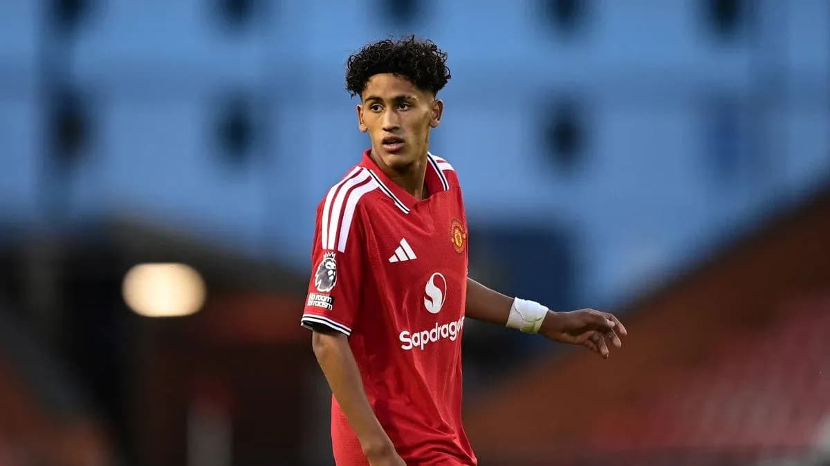Young player in Manchester United jersey on field Young player in Manchester United jersey on field