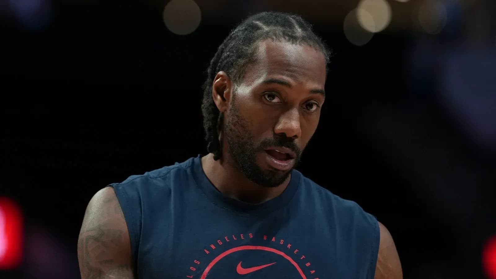 Basketball player in warm-up attire on court Basketball player in warm-up attire on court