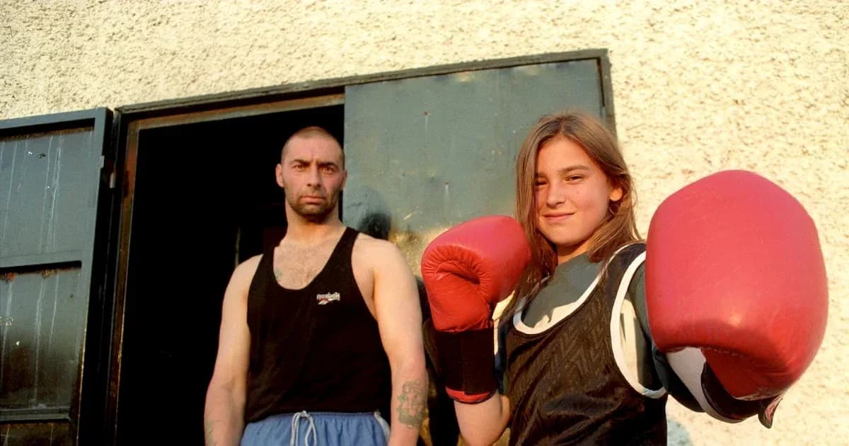 Young girl in boxing gloves with trainer outdoors Young girl in boxing gloves with trainer outdoors