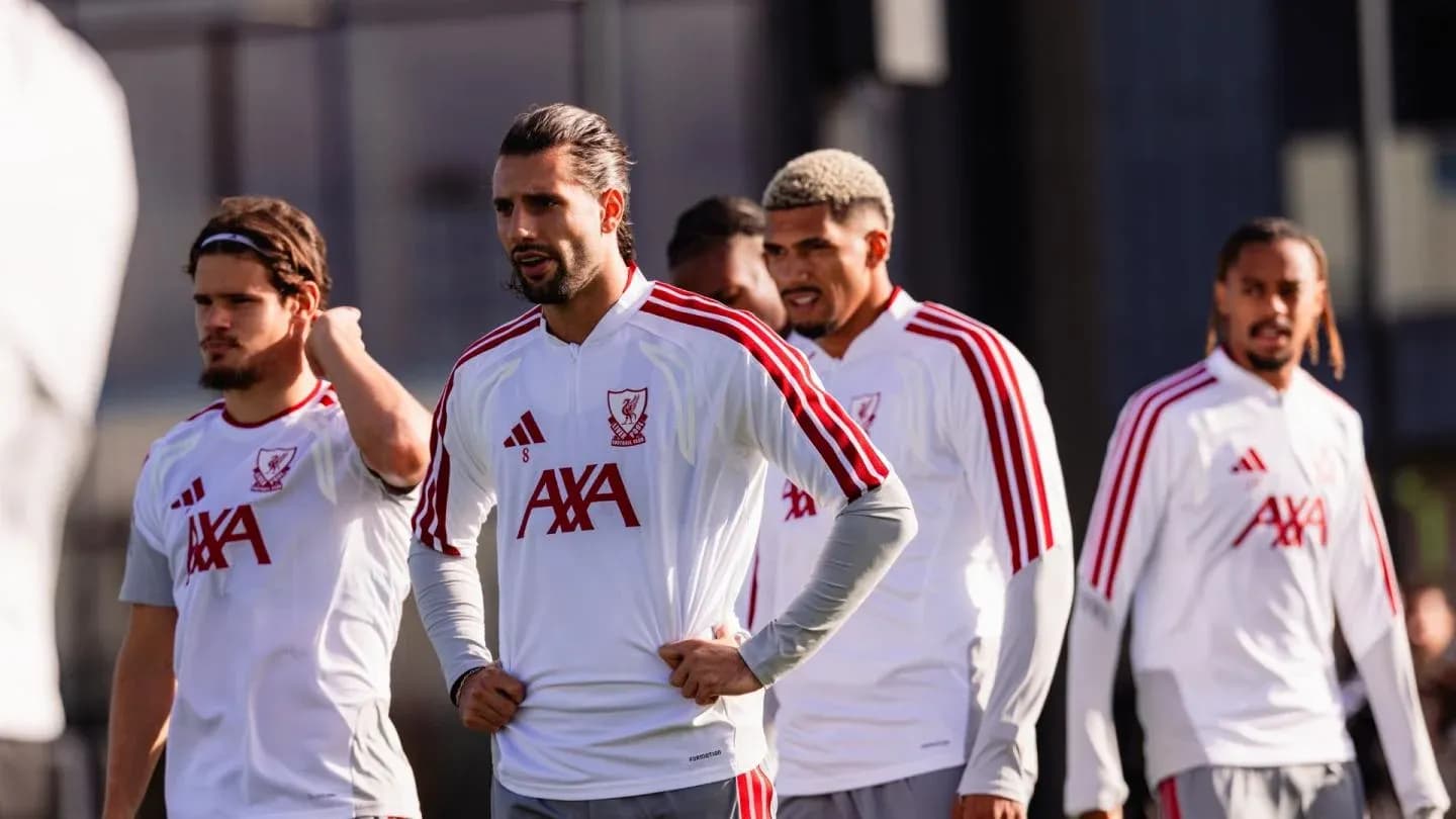 Players in Liverpool training kits during practice session Players in Liverpool training kits during practice session