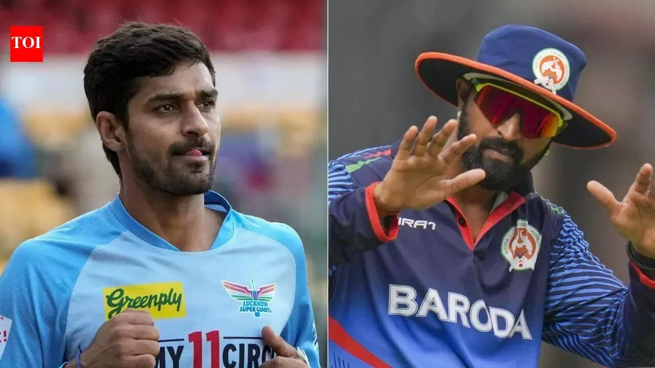 Two cricket players in team uniforms during match Two cricket players in team uniforms during match