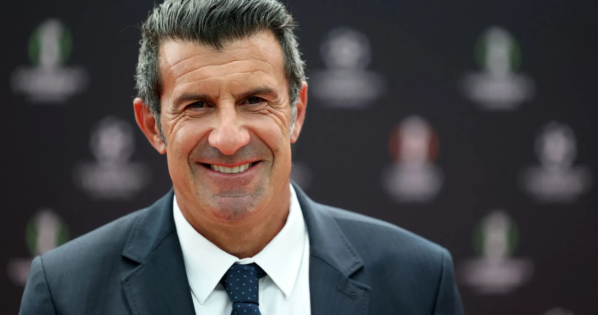 Man smiling in a formal suit at event Man smiling in a formal suit at event