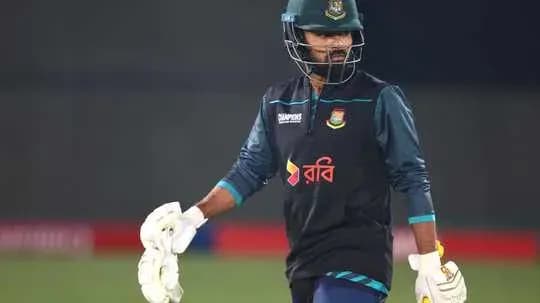 Cricketer wearing gloves during practice session Cricketer wearing gloves during practice session