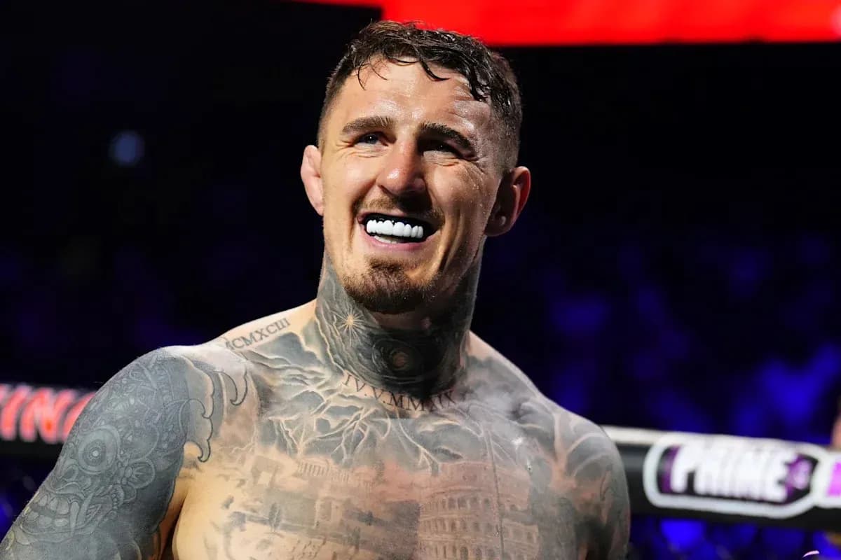 Boxer smiling with tattoos in ring Boxer smiling with tattoos in ring