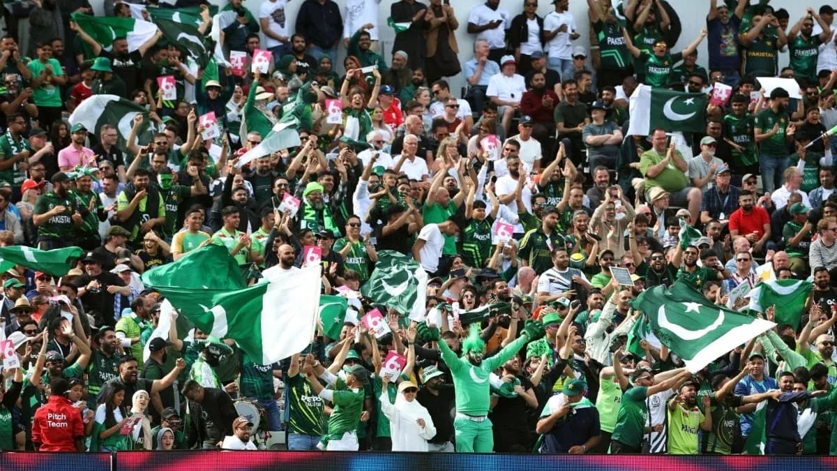 Pakistan cricket fans cheering with flags in stadium Pakistan cricket fans cheering with flags in stadium