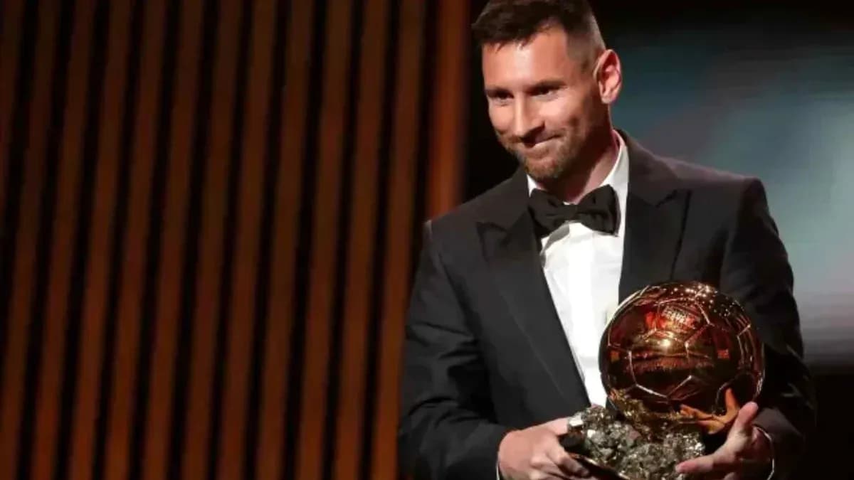 Lionel Messi holding Ballon d'Or award on stage Lionel Messi holding Ballon d'Or award on stage