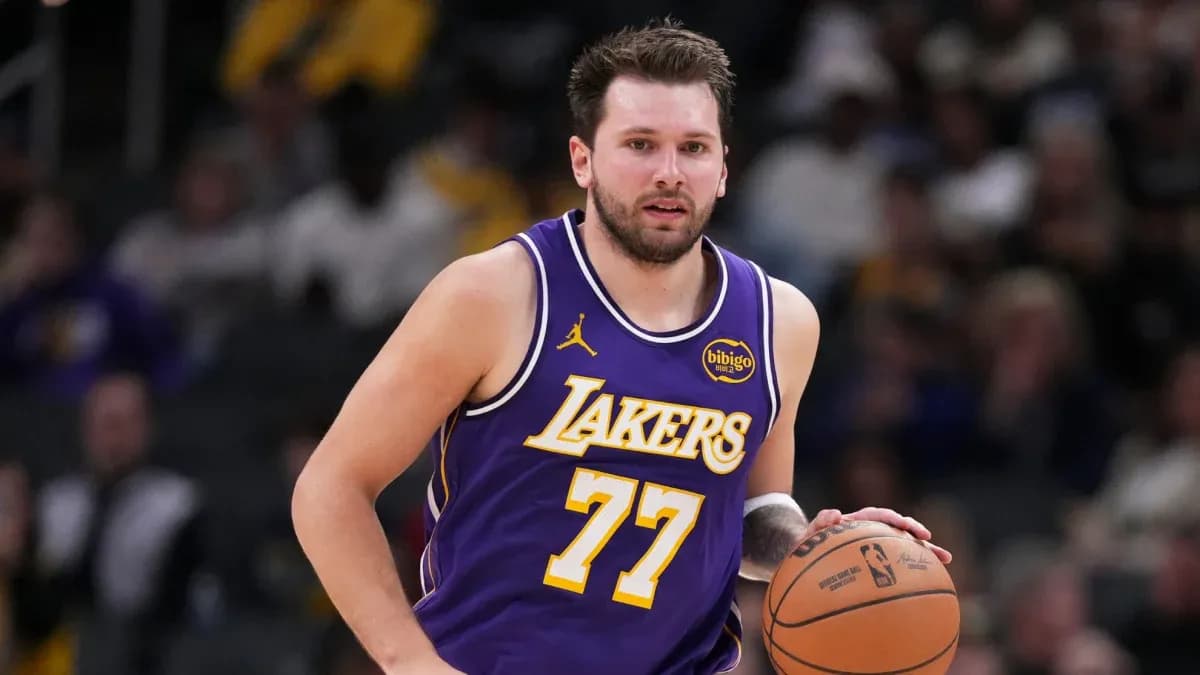 Player dribbling basketball in Lakers uniform Player dribbling basketball in Lakers uniform