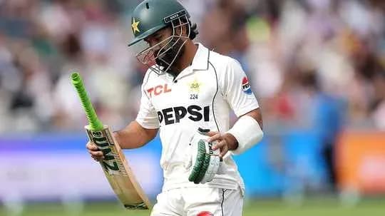 Cricketer walking off field holding bat and helmet Cricketer walking off field holding bat and helmet