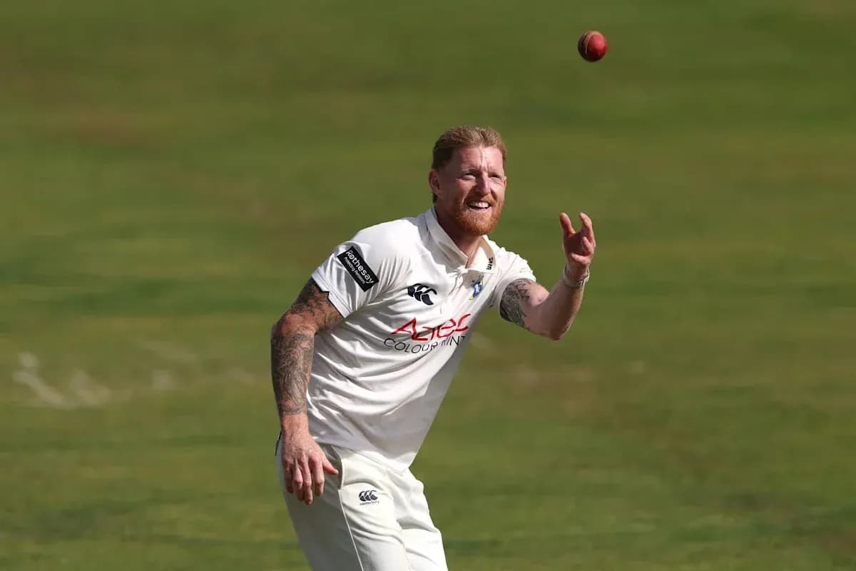 Cricketer catching a ball during a match Cricketer catching a ball during a match