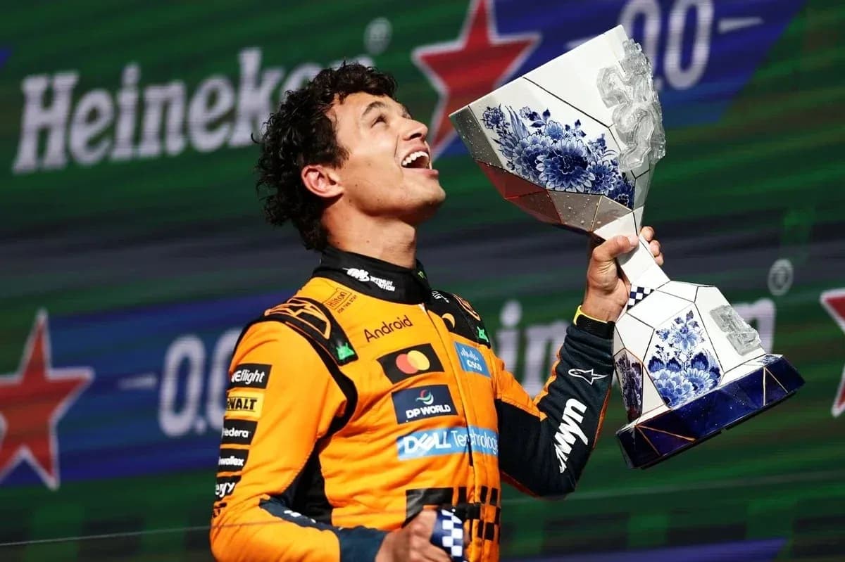 Driver celebrating with trophy on podium Driver celebrating with trophy on podium