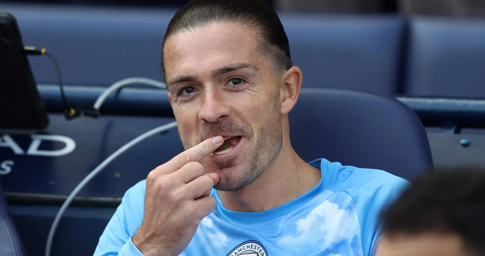 Player sitting on bench eating snack during match Player sitting on bench eating snack during match