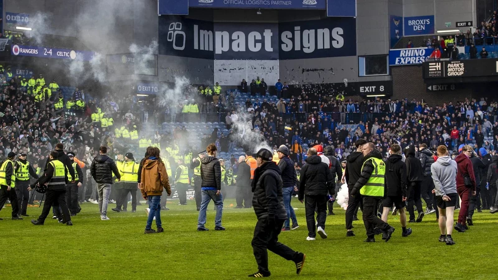 Fans and police on the pitch after match Fans and police on the pitch after match