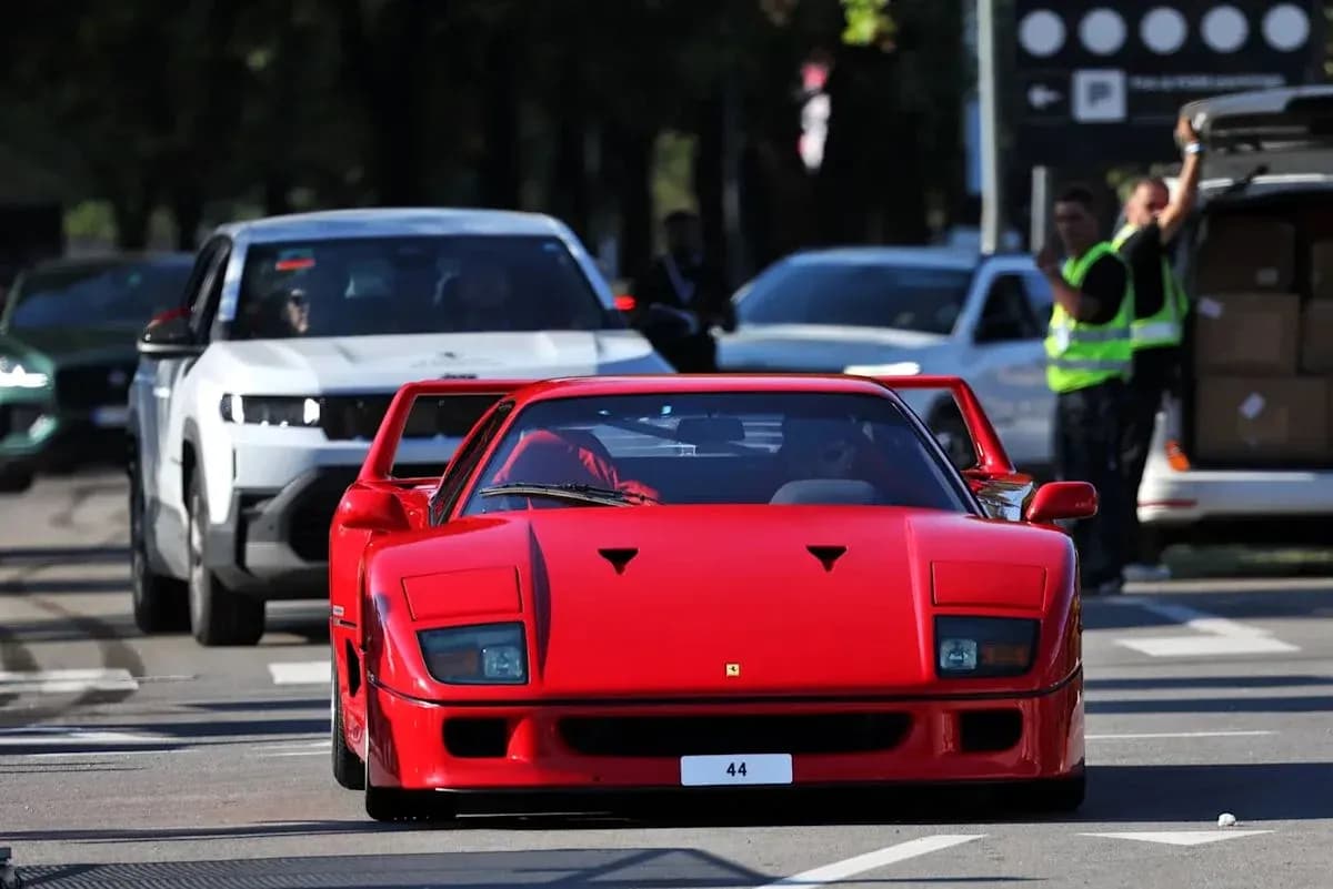 Red Ferrari F40 driving on city street Red Ferrari F40 driving on city street