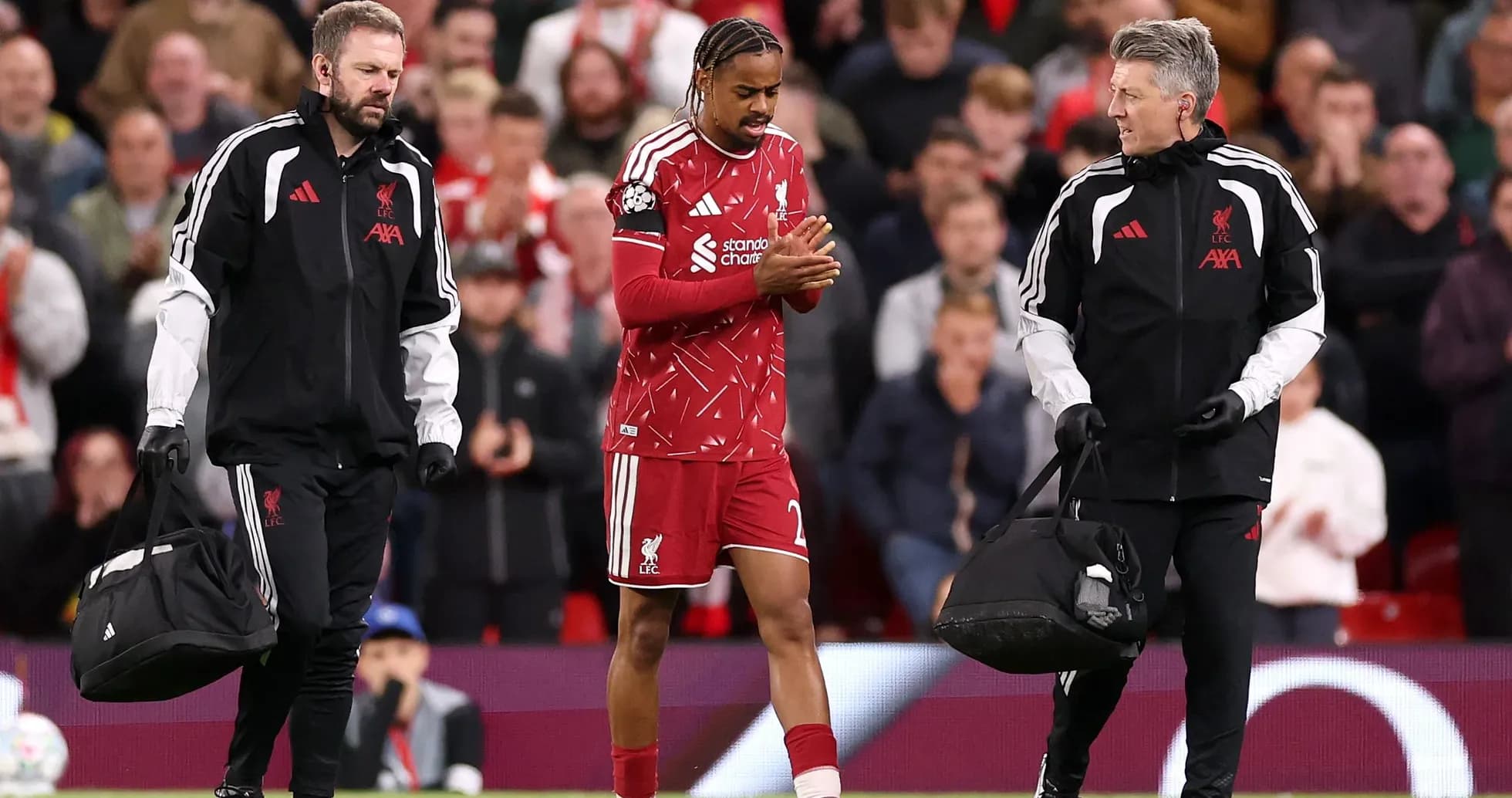 Liverpool player being assisted off the pitch Liverpool player being assisted off the pitch
