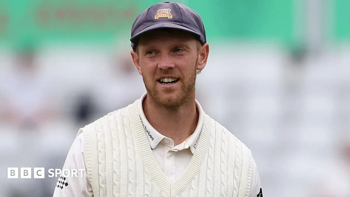 Cricketer wearing a white sweater on field Cricketer wearing a white sweater on field