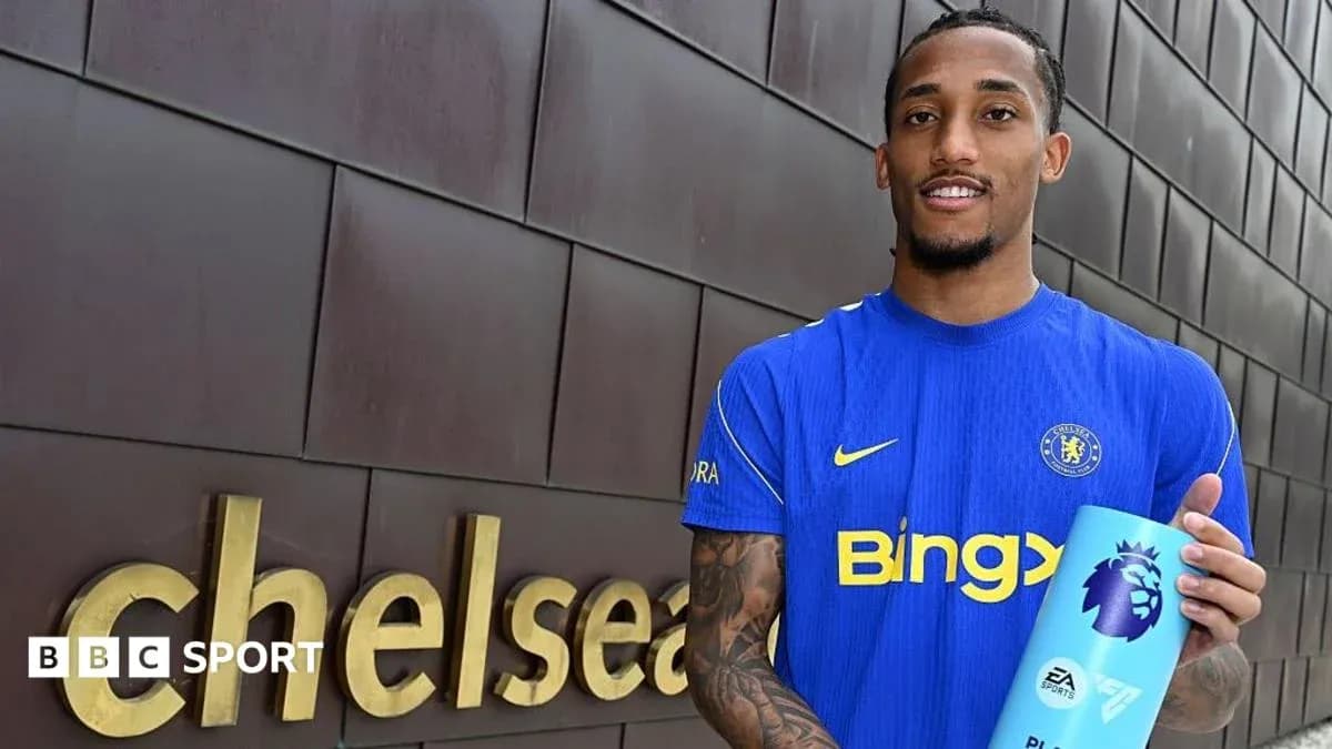 Player holding Premier League award outside Chelsea sign Player holding Premier League award outside Chelsea sign