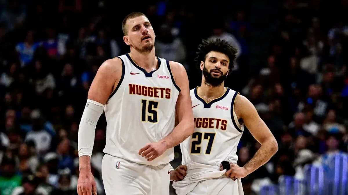 Two Denver Nuggets players walking off the court Two Denver Nuggets players walking off the court
