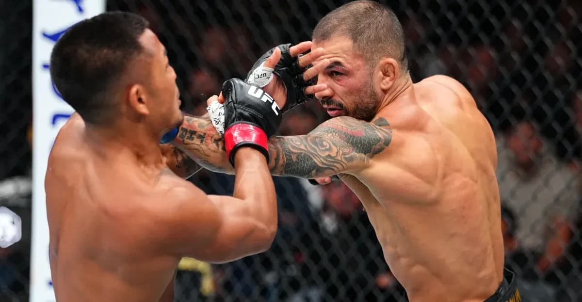 Two fighters exchanging punches in octagon match Two fighters exchanging punches in octagon match